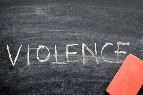 decorative image of a chalk board that says "Violence" written in chalk