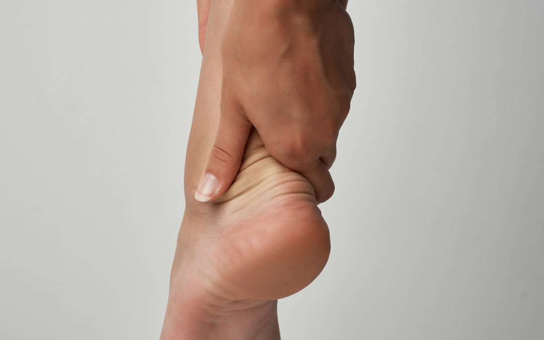 image of a woman's hand holding her ankle