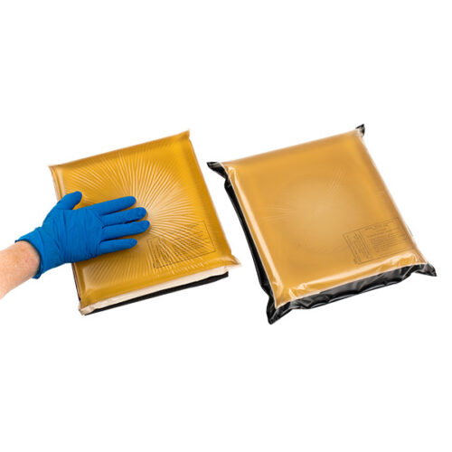 nurse demonstrating the firmness of a supine head pad