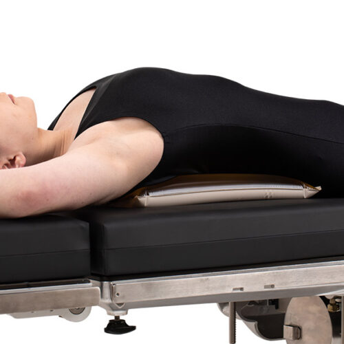 patient lying on top of a graduated thoracic positioner