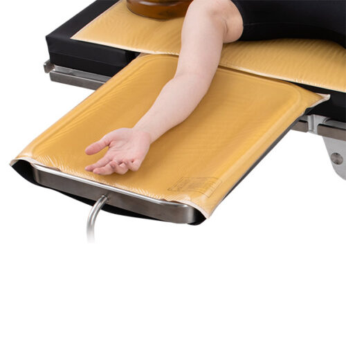 mayo stand with a patient's arm resting on it