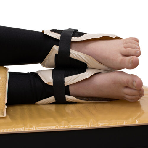 Heel protector pads wrapped around both heels of the patient.